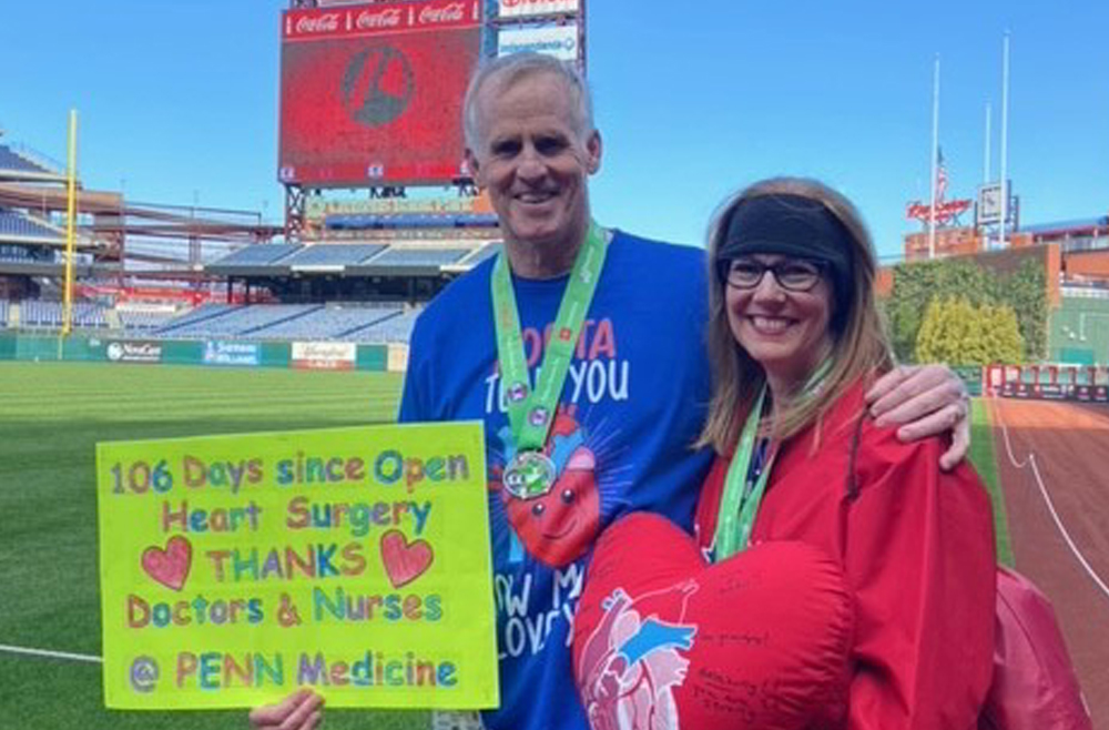 HUP nurse Megan Holland’s parents, John and Bernadette Marron, after running the Phillies Charities 5K in April. John ran while holding a sign thanking his Penn Medicine doctors and nurses.